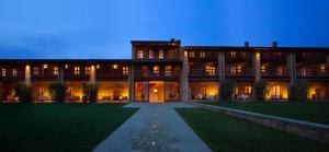 a large building with a lawn in front of it at Le Quattro Terre in Corte Franca