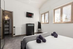 a bedroom with a bed and a flat screen tv at 8Min Airport Orio Al Serio - Attico Lusso e Terrazza in Seriate