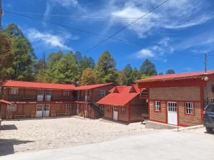 a group of buildings with red roofs at Cabañas Darely in Areponapuchi +11 photos