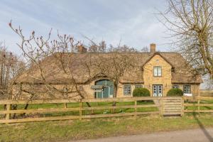 a house with a fence in front of it at Landhaus Westerkoog in Wisch