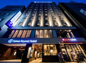 a tall building with a sign on the front of it at Daiwa Roynet Hotel Kokura Ekimae in Kitakyushu