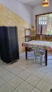 a living room with a bench and a tv at Casa da Jaca 02 in Itacaré