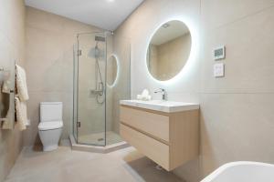 a bathroom with a shower and a sink and a toilet at Seabliss Retreat in Auckland +13 photos