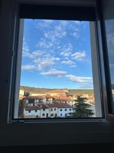 a window with a view of a city at Apartamentos COVARRUBIAS 3 ESTUDIO in Covarrubias