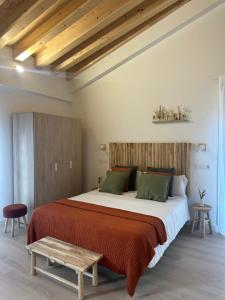 a bedroom with a large bed with a wooden headboard at Apartamentos COVARRUBIAS 3 ESTUDIO in Covarrubias +14 photos