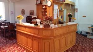 a large wooden counter with flowers on top of it at Hotel Cesmeli in Bursa