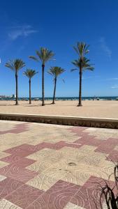 a group of palm trees on a sandy beach at Bahia Park Résidence in Cullera +14 photos