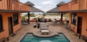 a patio with a pool and a table and chairs at Ocotillo del Mar in San Felipe