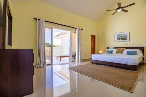 a bedroom with a bed and a sliding glass door at Pro Cab Paradise Condos Cabarete in Cabarete +62 photos