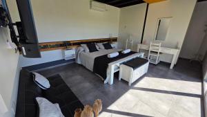 a bedroom with a bed and a tv and a couch at OlivaNegra Resort - Oliva2 in Maipú +63 photos