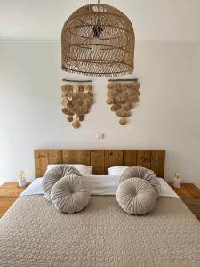 a bedroom with a bed with two pillows on it at Casa Copacabana in Mindelo