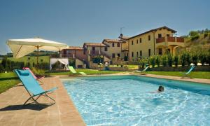 a person swimming in a swimming pool in a house at Borgo Le Capannelle in Castel Ritaldi