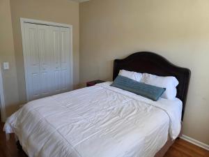 a bed with a blue pillow on top of it at Heaven on Earth - Large Bedroom with Private Bathroom in Raleigh
