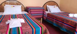 Postel nebo postele na pokoji v ubytování Paqariy lodge