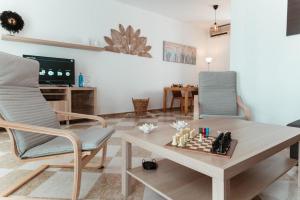 a living room with a chessboard on a table and two chairs at Rincón del Guadiana in Ayamonte