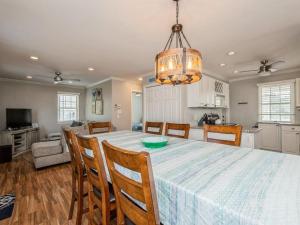 a dining room and kitchen with a table and chairs at Beach Badges Wifi Washerdryer Private Yard 14020 in Brant Beach