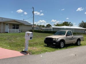 a truck parked next to a mailbox on the side of a street at Happy Rest Stop House in North Fort Myers