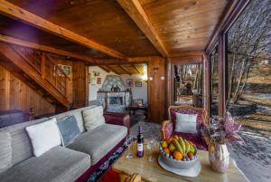 a living room with a couch and a table with a bowl of fruit at Montenegro Rustic House I in Bjeloši