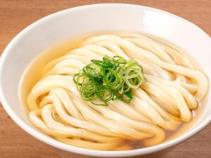 a bowl of noodle soup with noodles and green onions at APA Hotel Shibuya Dogenzakaue in Tokyo