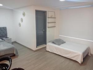 Postel nebo postele na pokoji v ubytování Hospedaje la Magia de Zipaquirá