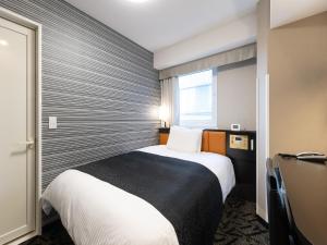 a hotel room with a bed and a window at APA Hotel Shibuya Dogenzakaue in Tokyo +37 photos