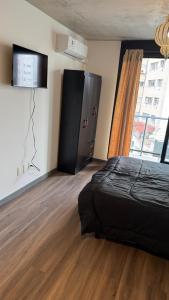 a bedroom with a bed and a large window at Be one FIT 26 in Montevideo +20 photos