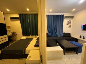 a living room with a bed and a couch at Tingis Concept in Tangier