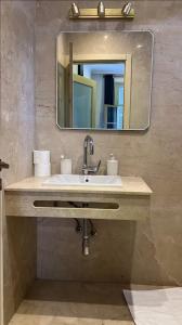a bathroom with a sink and a mirror at Tingis Concept in Tangier