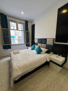 a bedroom with a large bed and a window at Tingis Concept in Tangier