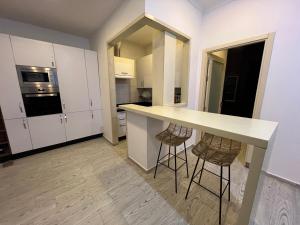 a kitchen with a counter and two stools at Tingis Concept in Tangier