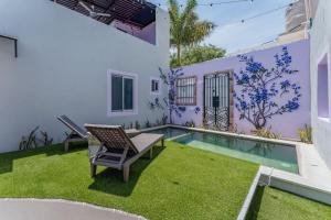 a patio with a chair and a swimming pool at Casa Lila in Mérida