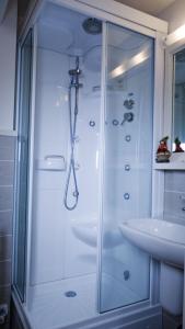 a bathroom with a shower and a sink at Hotel B&B Francolini in Folgaria