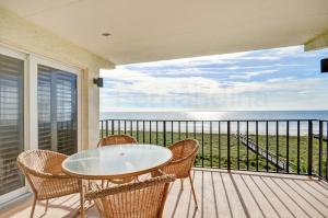 a table and chairs on a balcony with a view of the ocean at Oceanview Amelia South Condo in Fernandina Beach +23 photos