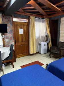 a bedroom with a bed and a table and a window at Hostal Puerta del Sol Molina in Molina