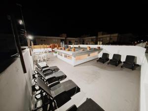 a deck with chairs and a swimming pool at night at La Casona de Antonio Sosa in Santa Maria de Guia de Gran Canaria +32 photos