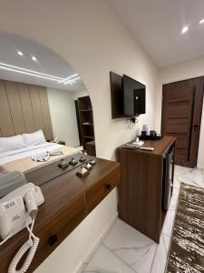 A bed or beds in a room at Inside Pyramids Hotel