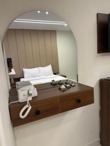 A bed or beds in a room at Inside Pyramids Hotel