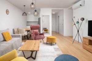 a living room with a couch and chairs and a table at Luxury Apartment Mona with Garden & Jacuzzi in Zadar, Borik in Zadar