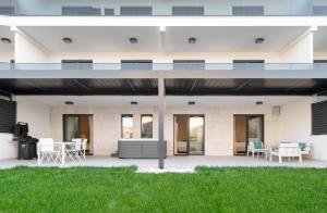 an exterior view of a building with grass at Luxury Apartment Mona with Garden & Jacuzzi in Zadar, Borik in Zadar