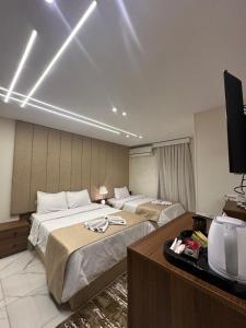 A bed or beds in a room at Inside Pyramids Hotel