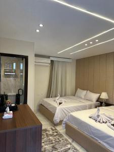 A bed or beds in a room at Inside Pyramids Hotel
