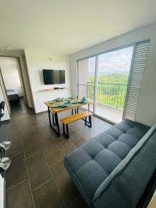 a living room with a couch and a table and a large window at Apartamento Campestre con Confort y Exclusividad in Flandes +95 photos