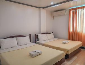 Postel nebo postele na pokoji v ubytování Boracay Paradise Hotel