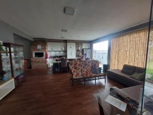 a large living room with a couch and a kitchen at Casa da lagoa com rampa para embarcações in Tramandaí