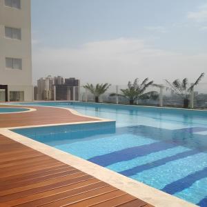a swimming pool on the roof of a building at iFlat Winner Sport Life Jardim Goiás in Goiânia