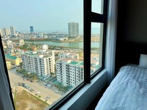 a bedroom window with a view of a city at Homestay Green Bay in Ha Long