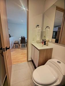 a bathroom with a white toilet and a sink at AH/Luxe penthouse con balcón,Wifi+Parking; Usaquén in Bogotá +42 photos