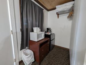a room with a microwave on top of a dresser at Squaw Valley Motel Room 6 in Squaw Valley
