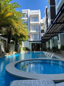 a large swimming pool in front of a building at Boracay Haven Suites in Boracay
