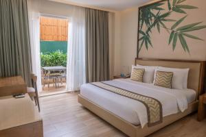 a hotel room with a bed and a balcony at Boracay Haven Suites in Boracay